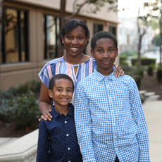 An African American family of three April (mom), Evan, and Ethan posing for a photo.