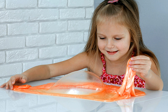 Girl playing with slime toy