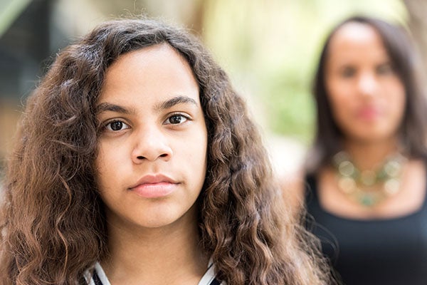 Girl with mom in background