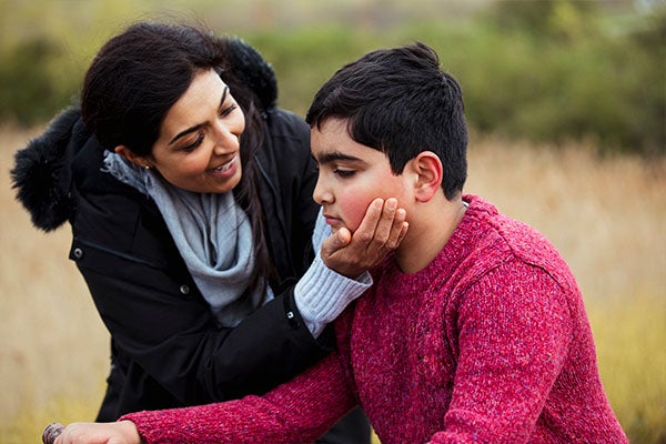 Mom cupping son's chin