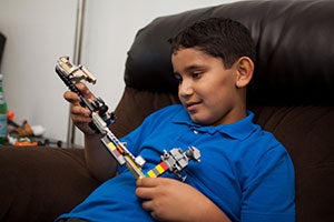 Photo of Adam holding a toy