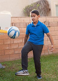 Photo of Adam playing Soccer