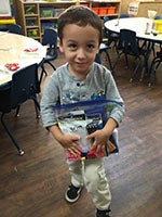 Boy from CDC Holding CVS School Supplies