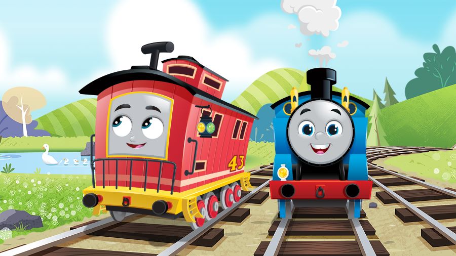 A blue train with a smiling face sits on the tracks next to a red train who is smiling while looking away.