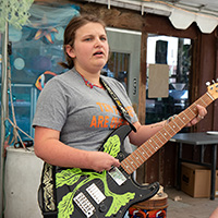 A female camper plays guitar