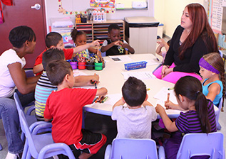 CDC students and teachers sitting around a table