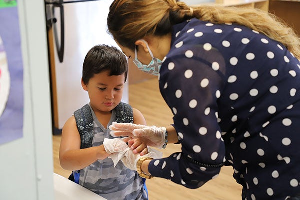 CDC Ventura teacher tending to boy