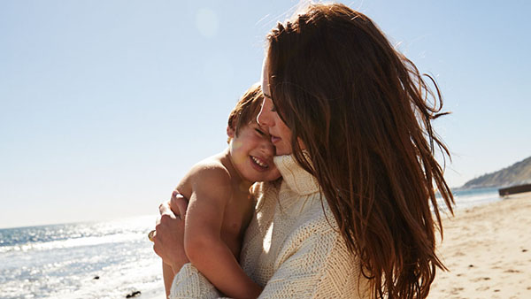 Claire Khodara holding son on the beach
