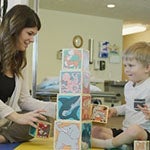 Teacher and child playing with blocks