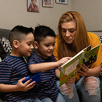 Living Options Carmen reading to her boys