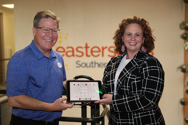 Bruce Fleming (left) an Augmentative and Alternative Communication (AAC) consultant for Talk To Me Technologies, presents a Wego 10A speech-generating device to Natalie Jauregui, MA, CCC/SLP, ATP, an AAC Coordinator in Autism Services for Easterseals Southern California.