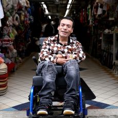 Daniel uses his new wheelchair out at his favorite market