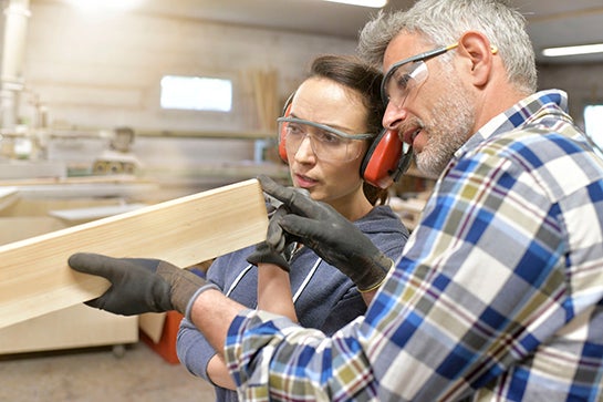 Carpenter teaching apprentice