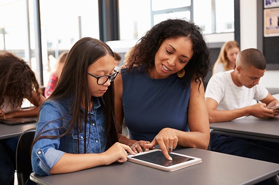 Teacher and student looking at a tablet