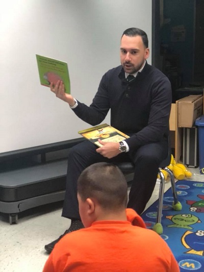 Employee reading to the kids
