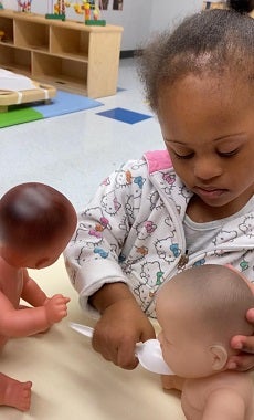 child with doll