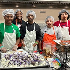 Culinary Arts students around chef's table