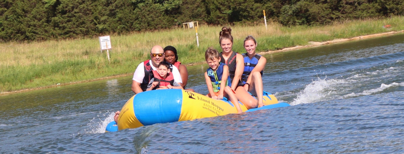 Family tubing on lake