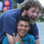 two boys hugging and smiling 