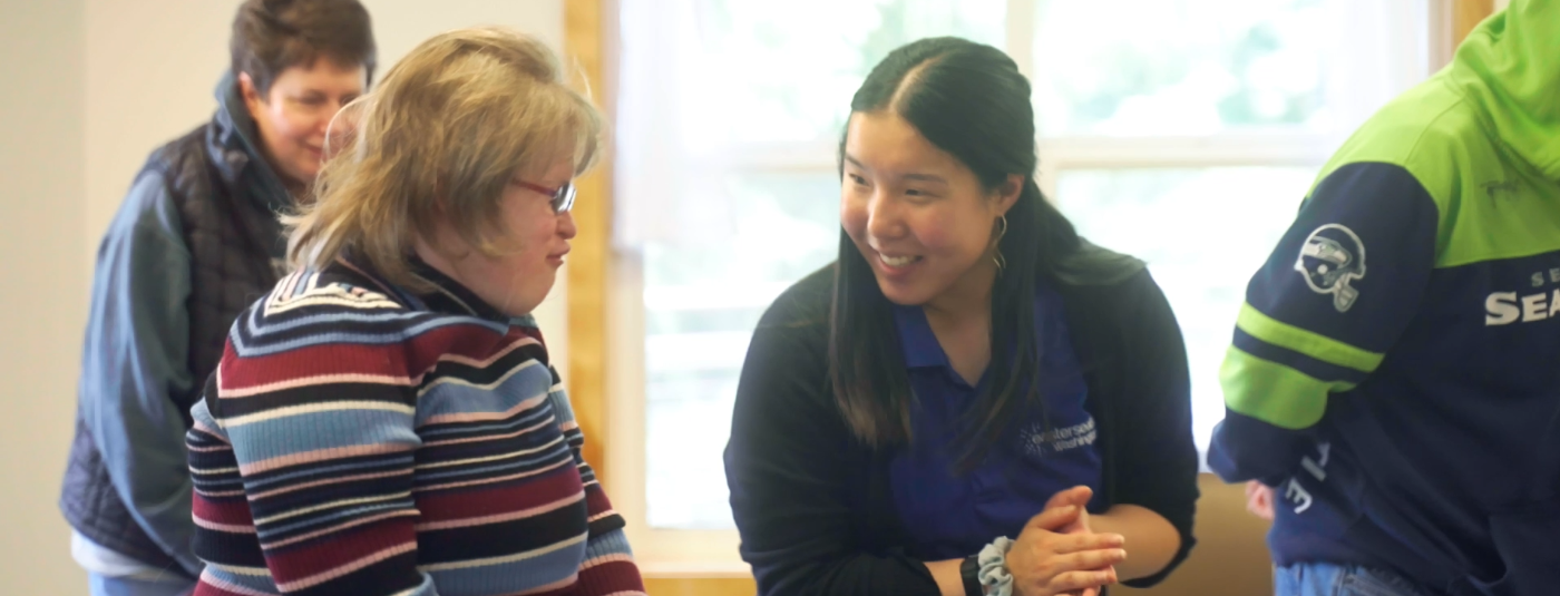 Staff member and participant at gateway engaging in an exercise activity.