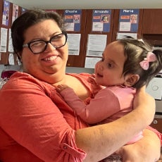 Selene holding a young girl